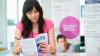 Woman in Thailand reads her IELTS practice book.