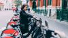 Thai woman hires a bicycle in Europe, after British Council classes on how to read directions in English